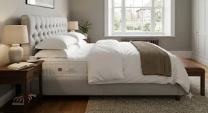 A luxury king size pocket sprung mattress on a stylish upholstered bed base in a UK master bedroom.